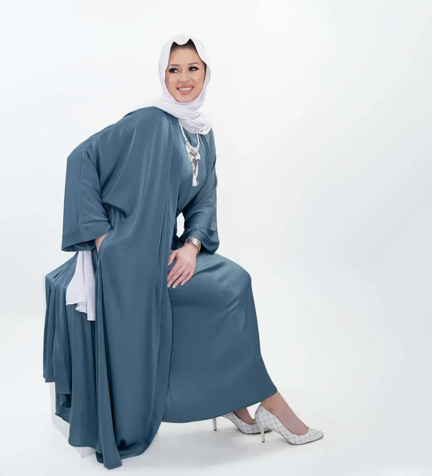 Three-piece silk Abaya set crafted from premium silk fabric, showcasing a captivating textured lines pattern. Includes a flowing gown, matching liner, and coordinating belt | Blue
