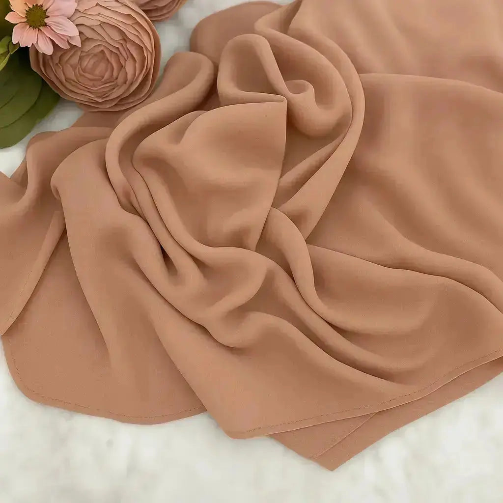 Peach chiffon hijab with elegant drape and soft texture
Lightweight peach hijab for modest fashion styling
Elegant peach hijab suitable for casual and formal looks | Peach Glow