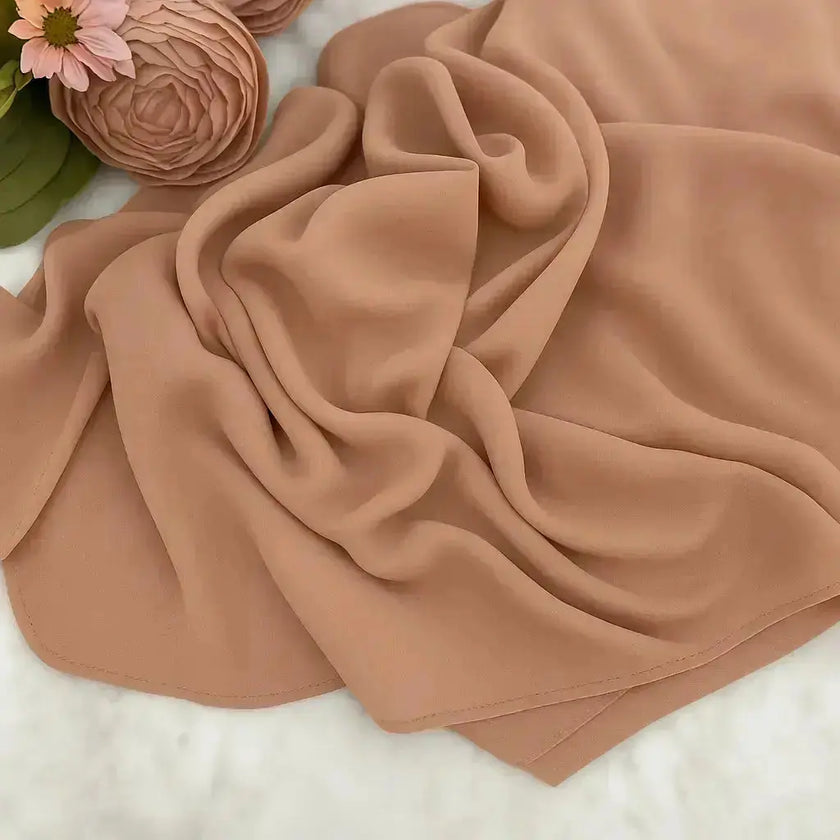 Peach chiffon hijab with elegant drape and soft texture
Lightweight peach hijab for modest fashion styling
Elegant peach hijab suitable for casual and formal looks | Peach Glow