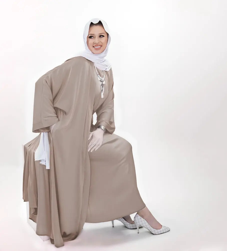 Three-piece textured silk abaya set with a flowing cardigan, matching liner, and adjustable belt for a sophisticated modest look. Lightweight, breathable | Beige