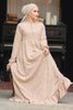 Muslim woman wearing a beige embroidered cotton maxi dress with ruffle hem and long sleeves, modest and breathable for casual or formal wear.