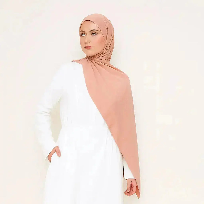 Peach chiffon hijab with elegant drape and soft texture
Lightweight peach hijab for modest fashion styling
Elegant peach hijab suitable for casual and formal looks | Peach Glow