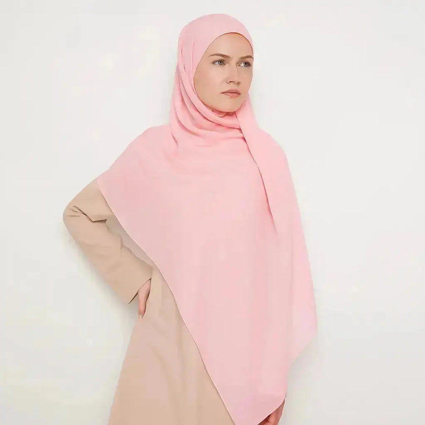 Elegant chiffon hijab in soft pink color with feminine style
Pink chiffon hijab draping beautifully, modest and elegant
Lightweight pink hijab perfect for daily wear or special occasions | Soft Pink