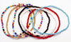 Set of seven anklets featuring multicolor beads, perfect for adding a pop of color to any outfit