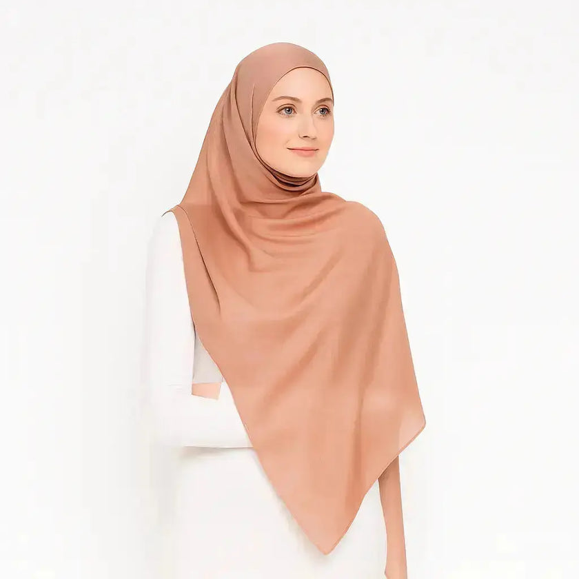 Peach chiffon hijab with elegant drape and soft texture
Lightweight peach hijab for modest fashion styling
Elegant peach hijab suitable for casual and formal looks | Peach Glow