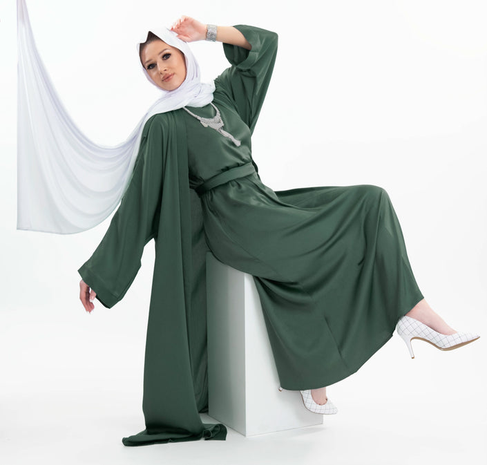 Three-piece silk Abaya set crafted from premium silk fabric, showcasing a captivating textured lines pattern. Includes a flowing gown, matching liner, and coordinating belt | Green