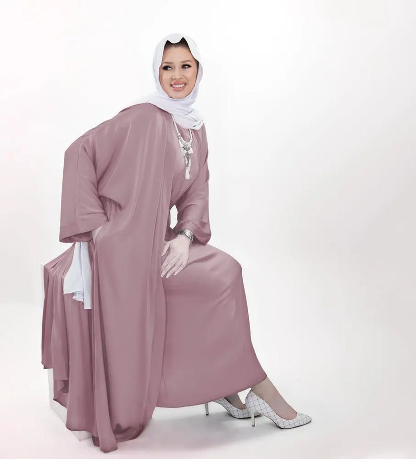 Three-piece silk Abaya set crafted from premium silk fabric, showcasing a captivating textured lines pattern. Includes a flowing gown, matching liner, and coordinating belt | Pink