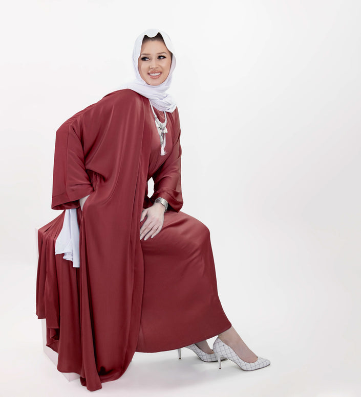 Three-piece silk Abaya set crafted from premium silk fabric, showcasing a captivating textured lines pattern. Includes a flowing gown, matching liner, and coordinating belt | Red