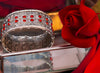 Silver hand cuff with red stones and elastic flexibility, adding sophistication and glamour to any outfit.