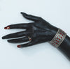 Silver hand cuff with red stones and elastic flexibility, adding sophistication and glamour to any outfit.