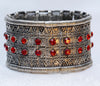 Silver hand cuff with red stones and elastic flexibility, adding sophistication and glamour to any outfit.