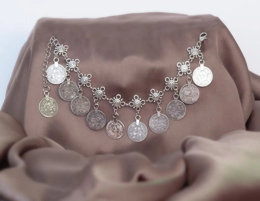 Silver anklet with coin charms, perfect for bohemian-inspired style