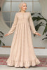 Muslim woman wearing a beige embroidered cotton maxi dress with ruffle hem and long sleeves, modest and breathable for casual or formal wear.