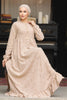 Muslim woman wearing a beige embroidered cotton maxi dress with ruffle hem and long sleeves, modest and breathable for casual or formal wear.