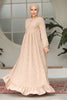 Muslim woman wearing a beige embroidered cotton maxi dress with ruffle hem and long sleeves, modest and breathable for casual or formal wear.