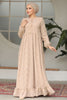 Muslim woman wearing a beige embroidered cotton maxi dress with ruffle hem and long sleeves, modest and breathable for casual or formal wear.