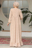 Muslim woman wearing a beige embroidered cotton maxi dress with ruffle hem and long sleeves, modest and breathable for casual or formal wear.