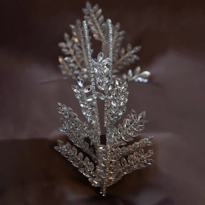 Elegant silver crystal bridal hairpiece featuring a leaf design with sparkling rhinestones. A perfect wedding headpiece for brides and formal occasions.