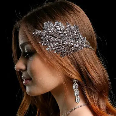 Elegant silver crystal bridal hairpiece featuring a leaf design with sparkling rhinestones. A perfect wedding headpiece for brides and formal occasions.