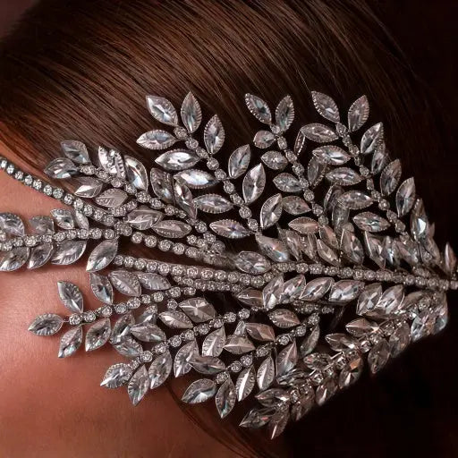 Elegant silver crystal bridal hairpiece featuring a leaf design with sparkling rhinestones. A perfect wedding headpiece for brides and formal occasions.