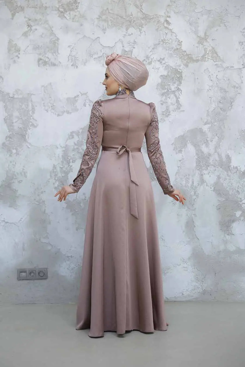Dusty Rose satin modest gown with long sleeves and intricate beaded embellishments. Elegant high-neck formal dress for weddings and special occasions.