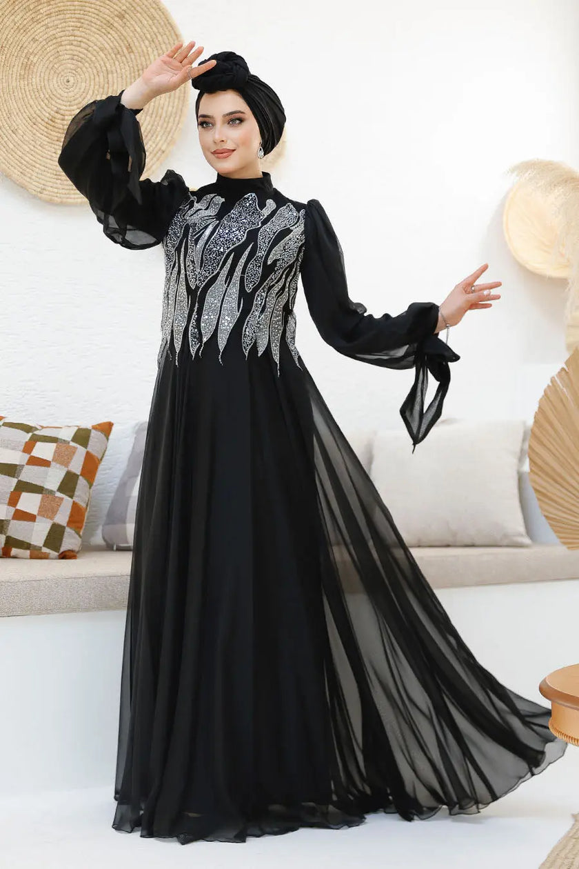 Modest midnight black chiffon gown with silver sequin embellishments on the bodice and back. Elegant full-length formal dress with flowy sleeves.