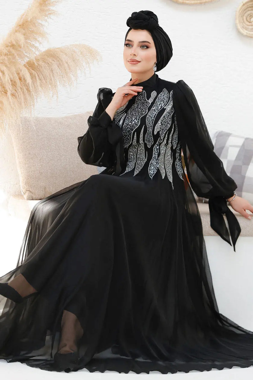Modest midnight black chiffon gown with silver sequin embellishments on the bodice and back. Elegant full-length formal dress with flowy sleeves.