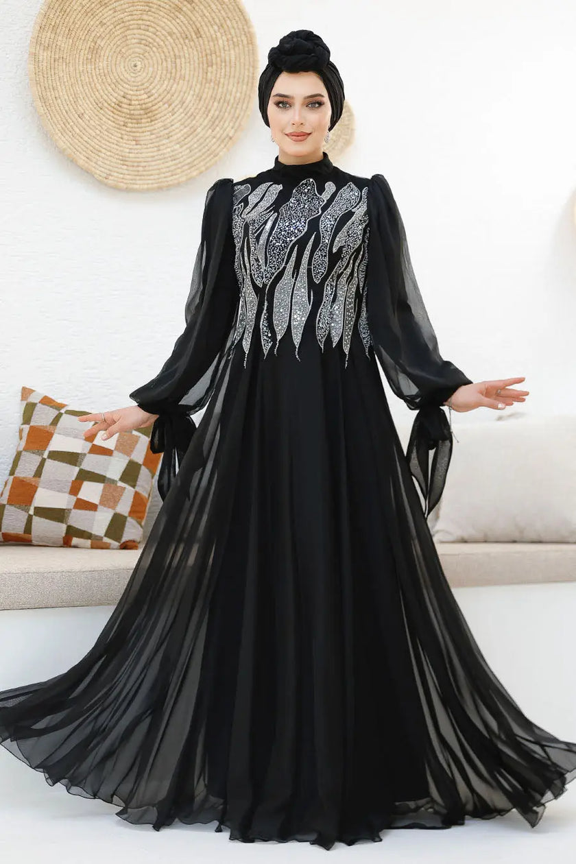 Modest midnight black chiffon gown with silver sequin embellishments on the bodice and back. Elegant full-length formal dress with flowy sleeves.