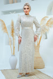 A woman wearing a modest silver sequin maxi gown with a satin waist belt, perfect for formal events and Eid – Zari Hijabeez