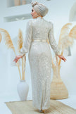 A woman wearing a modest silver sequin maxi gown with a satin waist belt, perfect for formal events and Eid – Zari Hijabeez