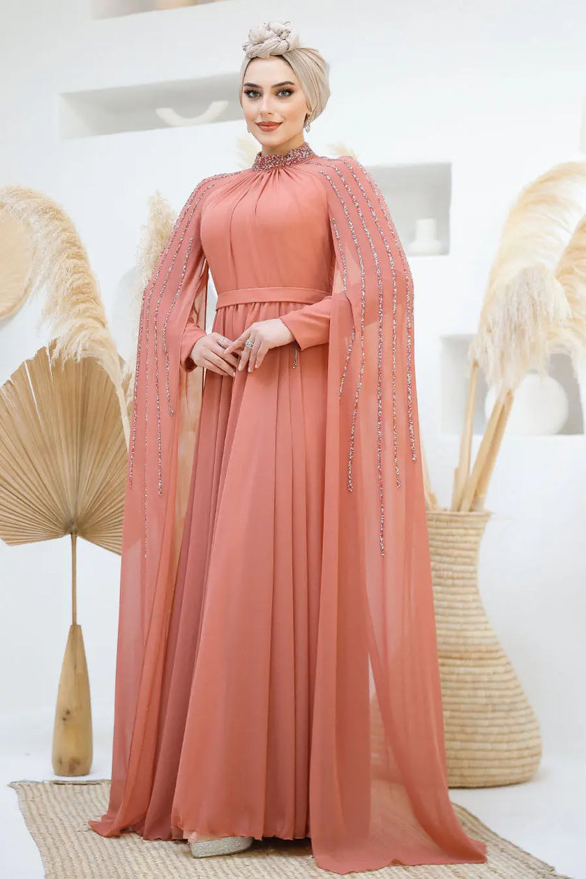 Terracotta rose chiffon gown with modest high neckline and elegant beaded embellishments on shoulders and cape sleeves. Perfect for weddings and special events.
