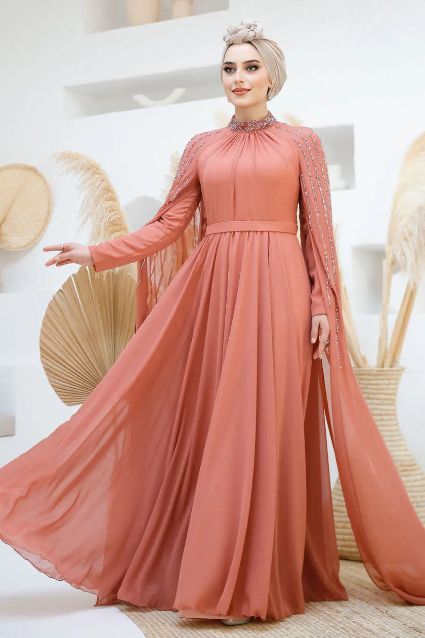 Terracotta rose chiffon gown with modest high neckline and elegant beaded embellishments on shoulders and cape sleeves. Perfect for weddings and special events.