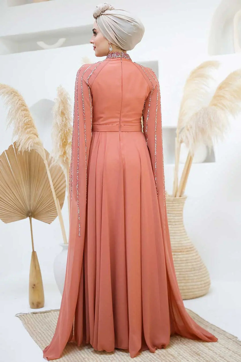 Terracotta rose chiffon gown with modest high neckline and elegant beaded embellishments on shoulders and cape sleeves. Perfect for weddings and special events.